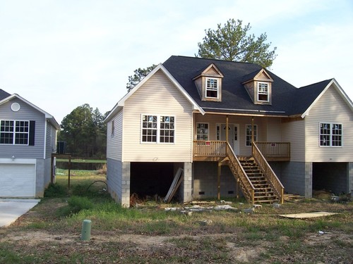 St. Andrews, SC: An unfinished duplex in Saint Andrews, South Carolina, on Rolling Hills Road. A pond lies behind it.