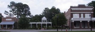 Meggett, SC: This is Meggett's Town Center which includes the Town Hall and the SCPA Bldg connected by a covered walkway(Pavilion). The building on the right is the Town Hall. The SCPA Bldg on the left is leased out downstairs to businesses and the upstairs is used by the town and residents for receptions etc. The town renovated the SCPA (South Carolina Produce Association) Bldg in 2004. If was used in the early 1900 by local farmers to buy and sell their product which was then put on the train across the street to ship all over the US.