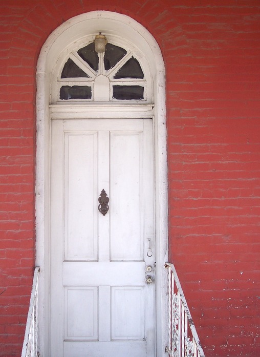 Calvert, TX: white door on red brick