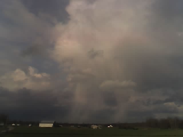 Flaherty, KY: I toke this with my phone as we stopped to get the mail this field is rite on the other side of my drive way. It was a stormy day and the winds were rough . We thought it looked like the wind was rolling the clouds in this tornado like shape.And if you look ready hard there are this colors of blue and pink in the clouds.There is just so much to this picture.