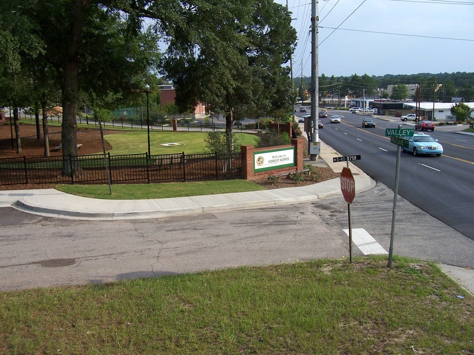 Forest Acres, SC: The corner of Valley Road and Beltline Boulevard. The Welcome to Forest Acres sign is over 500 meters inside the actual boundaries of Forest Acres, installed on the fence of this city-owned park property for expedience's sake.