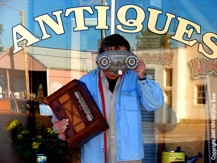 Ruthven, IA: "Take me to your leader ...of antique bargains!," is what this alien-dressed Ruthven resident is most probably not asking as he begrudgingly poses for this comical shot, in front of this town's premier antique/curio shop, located on Main Street.