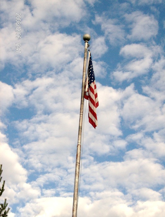 Orting, WA: Photo taken during town parade for Christmas, walking around town. Our flag stands tall and sky is blue! Amazing sight.