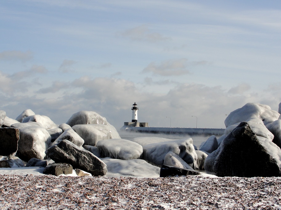 Duluth, MN: Lighthouse and ice covered rocks on Lake Superior in Duluth, MN