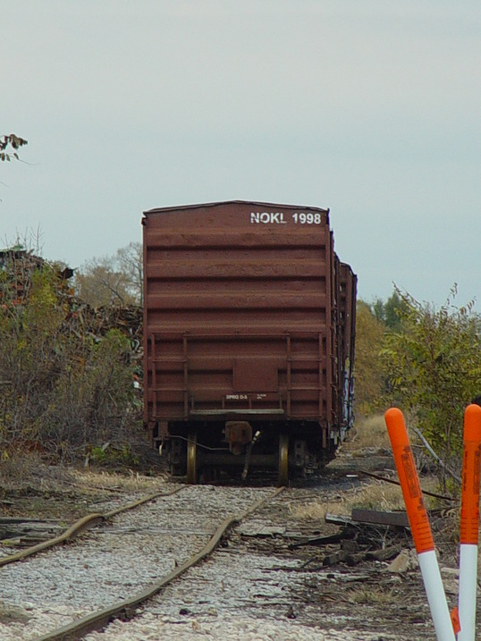 Moline, IL: railroad car by 34th street and river by salvage yard in Moline