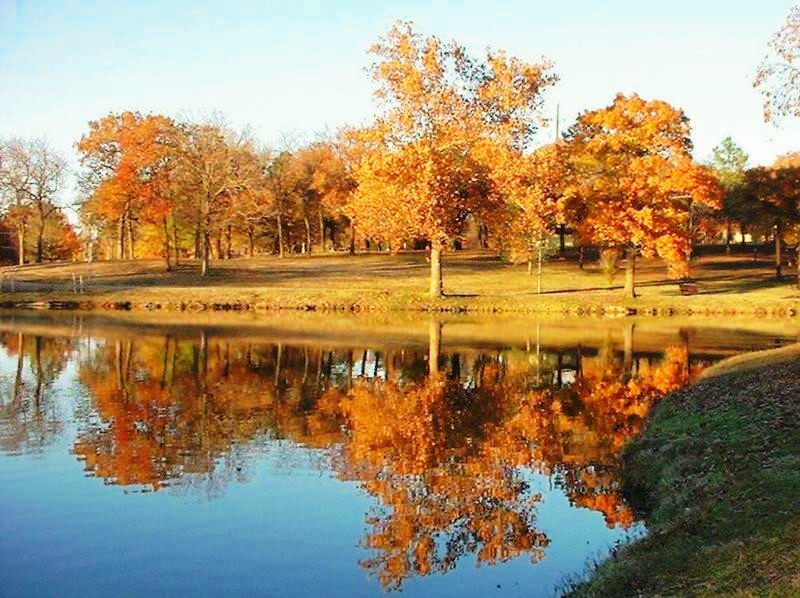 Ada, OK: Brilliant autumn colors reflect in Wintersmith Lake.