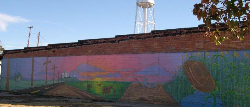 Rolla, KS: Mural painted by resident depicting area life.