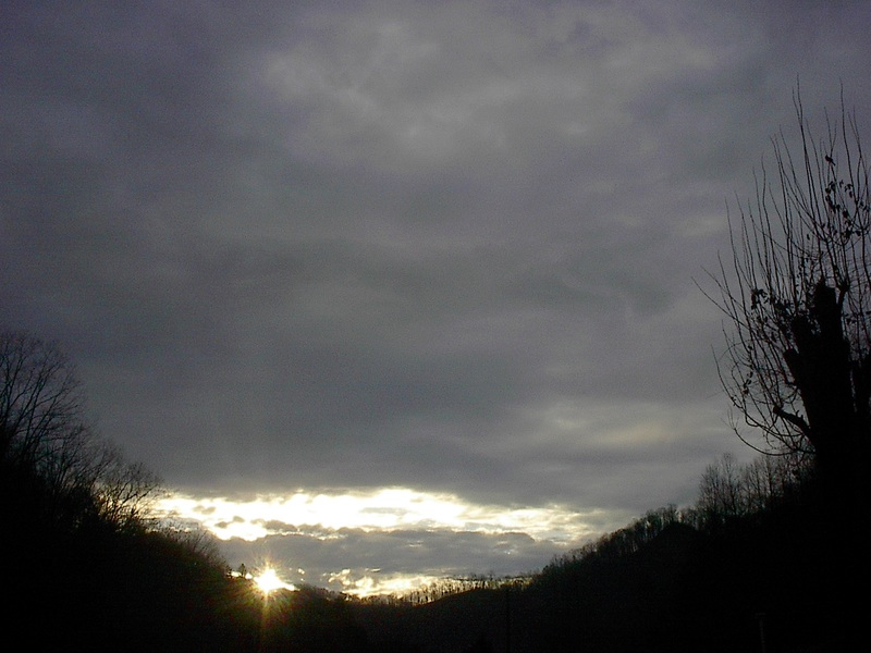 Pippa Passes, KY: Puffy Black Rain Clouds With A Touch of Sun In Pippa Passes.