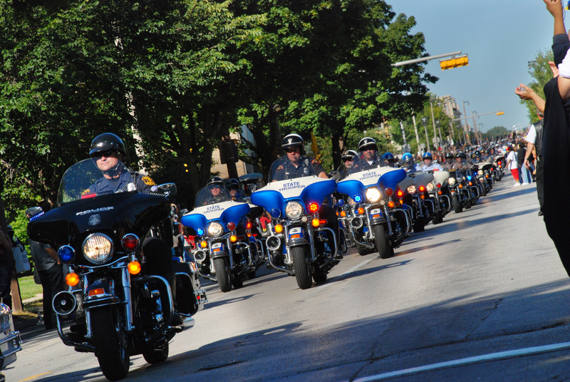 Milwaukee, WI: Officers riding Harley Davidson Motorcycles down Wisconsin Ave for the 105th Anniversary of Harley Davidson