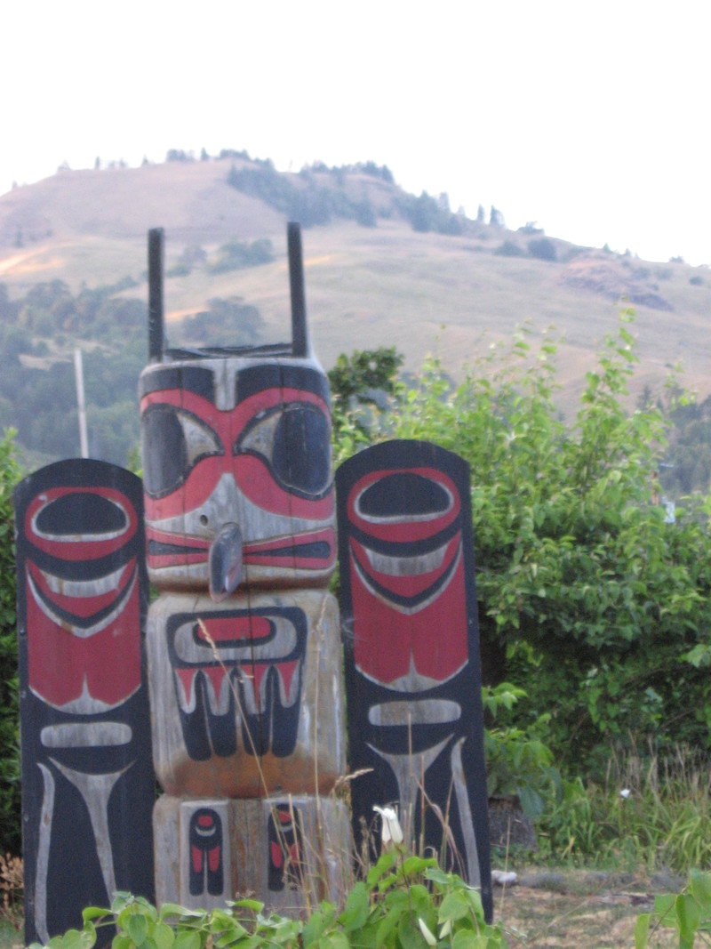 Powers, OR: Beautiful totem pole in the downtown residential area of Powers showing the mountains surrounding this historic valley