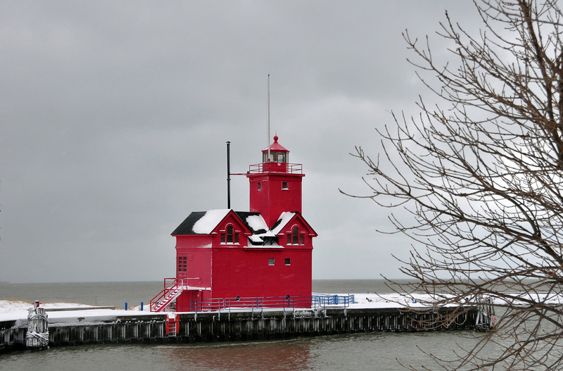 Holland, MI: Big Red in the winter with snow on areas of the lighthouse.