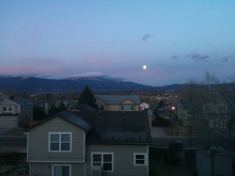 Colorado Springs, CO: Early morning moon setting over Pikes Peak.