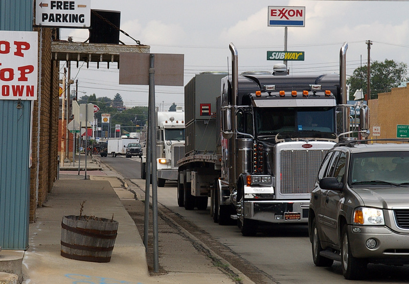 Clarendon, TX TRUCKS rumble eastward through downtown along U.S