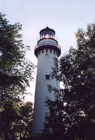 Evanston, IL: 1879 lighthouse catches setting sun on Lake Michigan shoreline