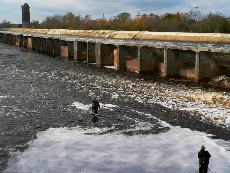 Manistique, MI: Two guys fishing in log flume in Manistique, MI