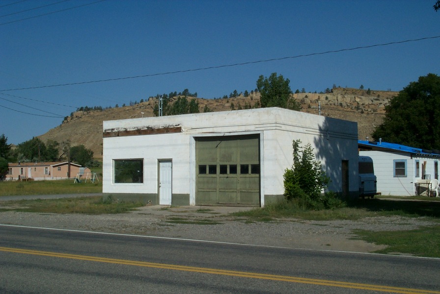 Park City, MT: Remains of 1960's era Texaco service station on old US 10 highway. With the completion of Interstate 90, this gas station was bypassed by the new freeway and eventually went of of business. The sandstone bluffs in the background were probably the likely source of the stone used in many of the early buildings of Park City.