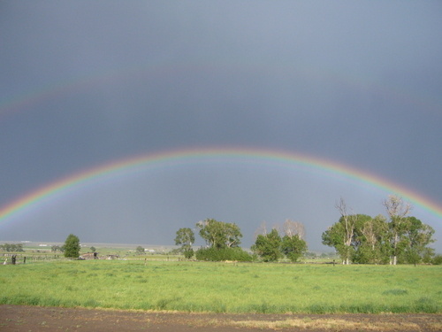 Panguitch, UT: A rainbow over a field of green