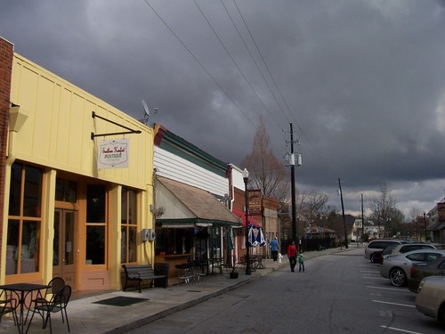 Conyers, GA: A view of the west-facing storefronts on Commercial Street in historic "Olde Town" Conyers, Georgia on a cloudy February afternoon.