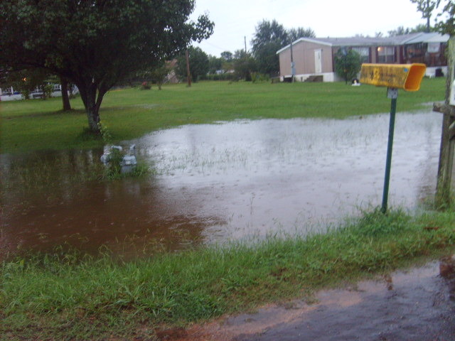 Hooks, TX: Flooded ditch overflowing into yard on Browning