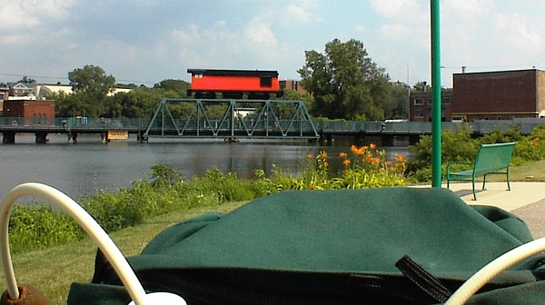 Beloit, WI: Fishing bridge above dam. Train is part of public art project. View is south down river while riding bike on west side river path.